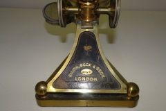 Microscope on cast triangular base with engraved serial number 4297